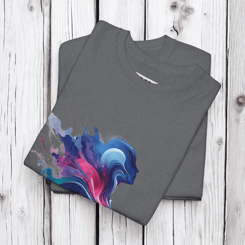 Gray cotton t-shirts with abstract blue and pink splash design folded neatly on a light wooden surface