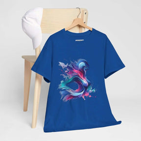 Blue cotton t-shirt with vibrant abstract front design draped over wooden chair next to a white baseball cap