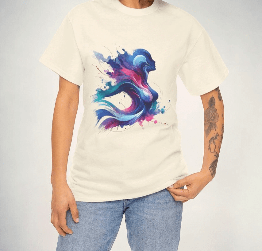 White cotton t-shirt featuring an abstract blue and pink graphic design, worn with jeans by a tattooed person