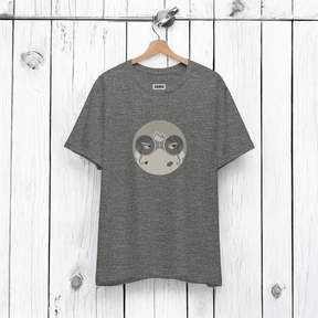 Gray tee with circular graphic of face with closed eyes in gray shades, "SAROO" brand on white wood panel