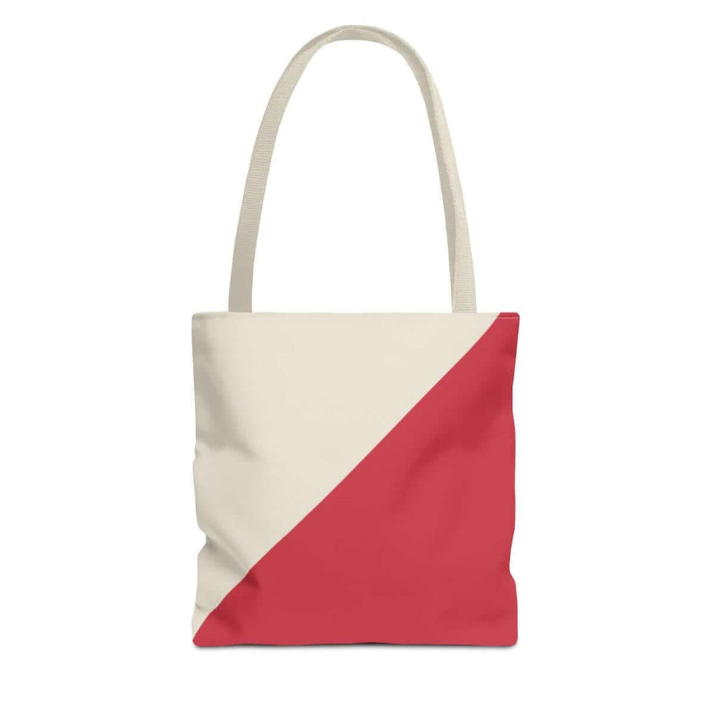 Canvas tote bag with cream base and bold red diagonal stripe, featuring dual shoulder straps and boxy silhouette