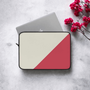 Two-toned dark grey laptop sleeve with fabric texture and angled color-block design on concrete surface