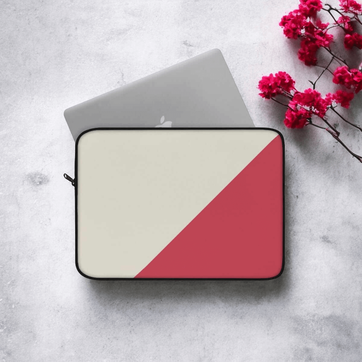 Two-toned dark grey laptop sleeve with fabric texture and angled color-block design on concrete surface
