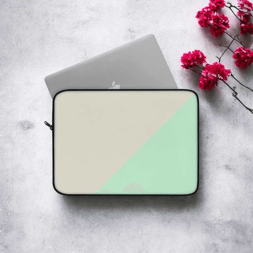 Laptop sleeve with beige canvas body and mint green zipper detailing, set beside vivid red flowers on gray surface