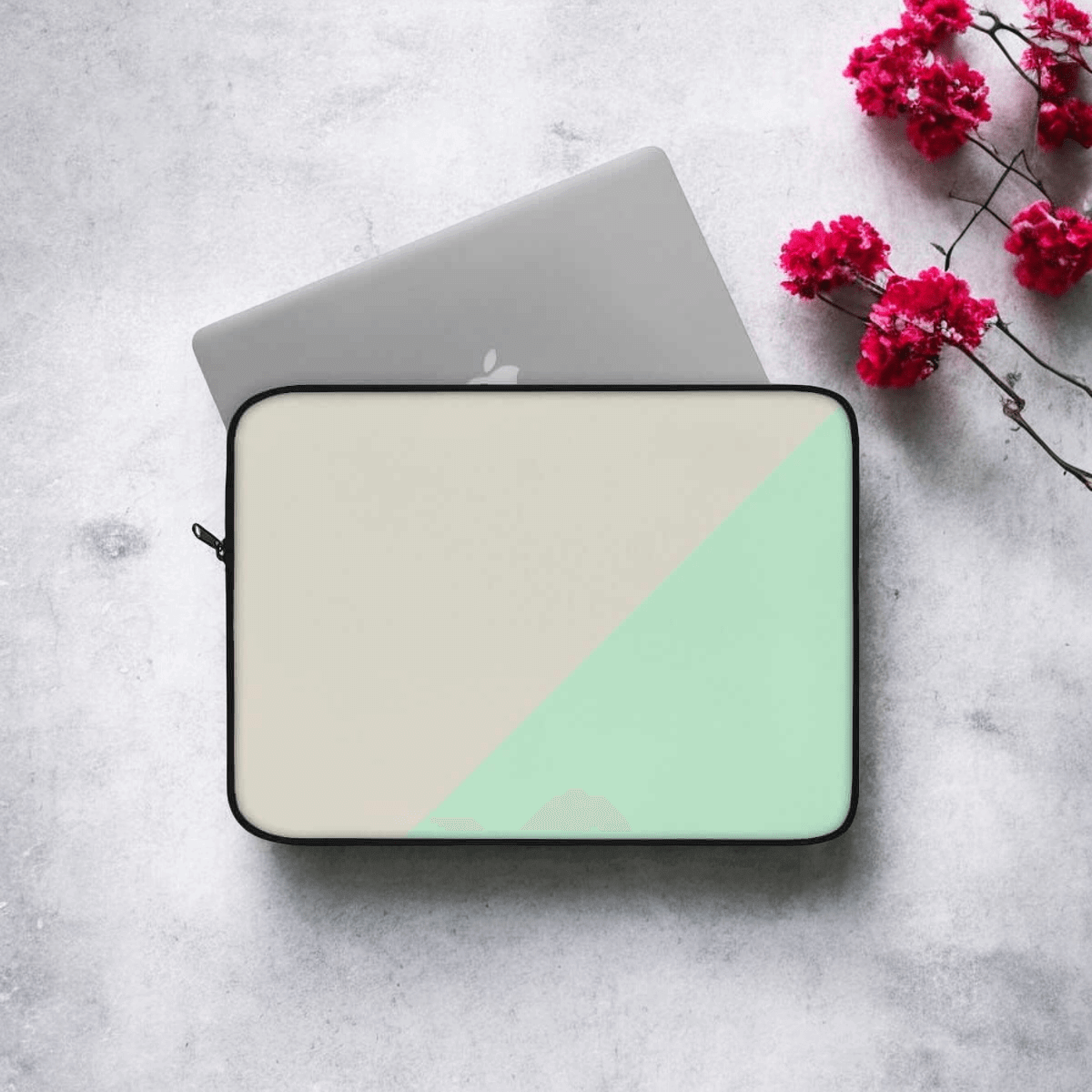 Laptop sleeve with beige canvas body and mint green zipper detailing, set beside vivid red flowers on gray surface