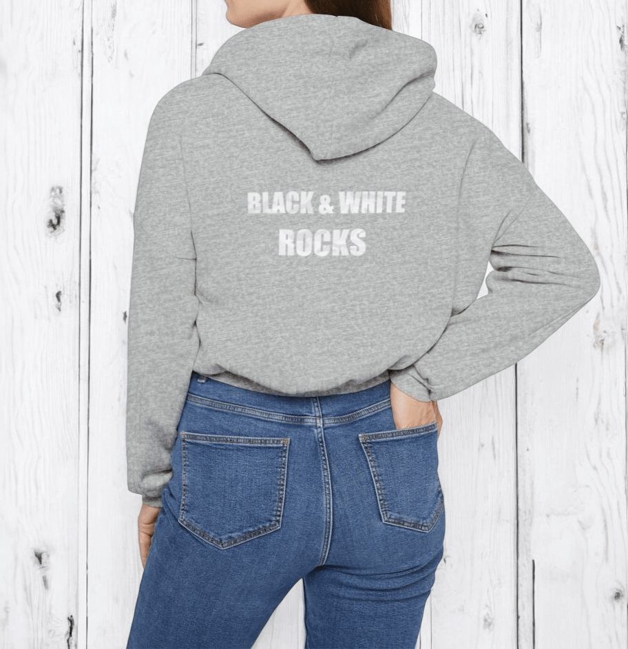 Gray cotton hoodie with front kangaroo pocket and 'Black & White Rocks' text paired with blue denim jeans