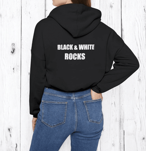 Black cotton hoodie with bold white 'BLACK & WHITE ROCKS' text on front, worn with medium wash denim jeans