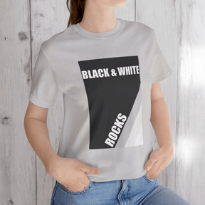 Person in silver t-shirt with black and white rock print reading 'BLACK & WHITE ROCKS' and jeans