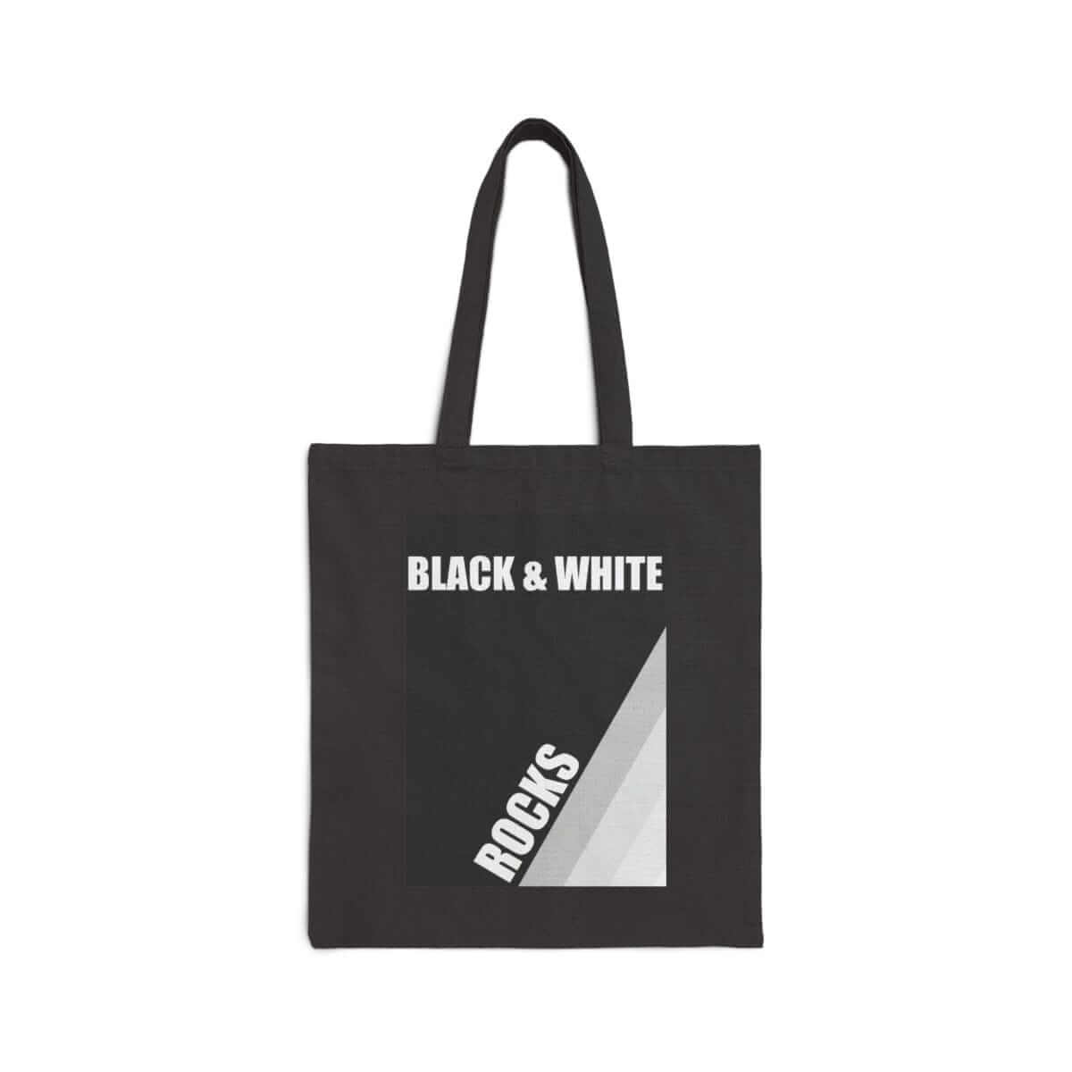 Black and white canvas tote bag with rock print design, featuring sturdy handles and a rectangular shape