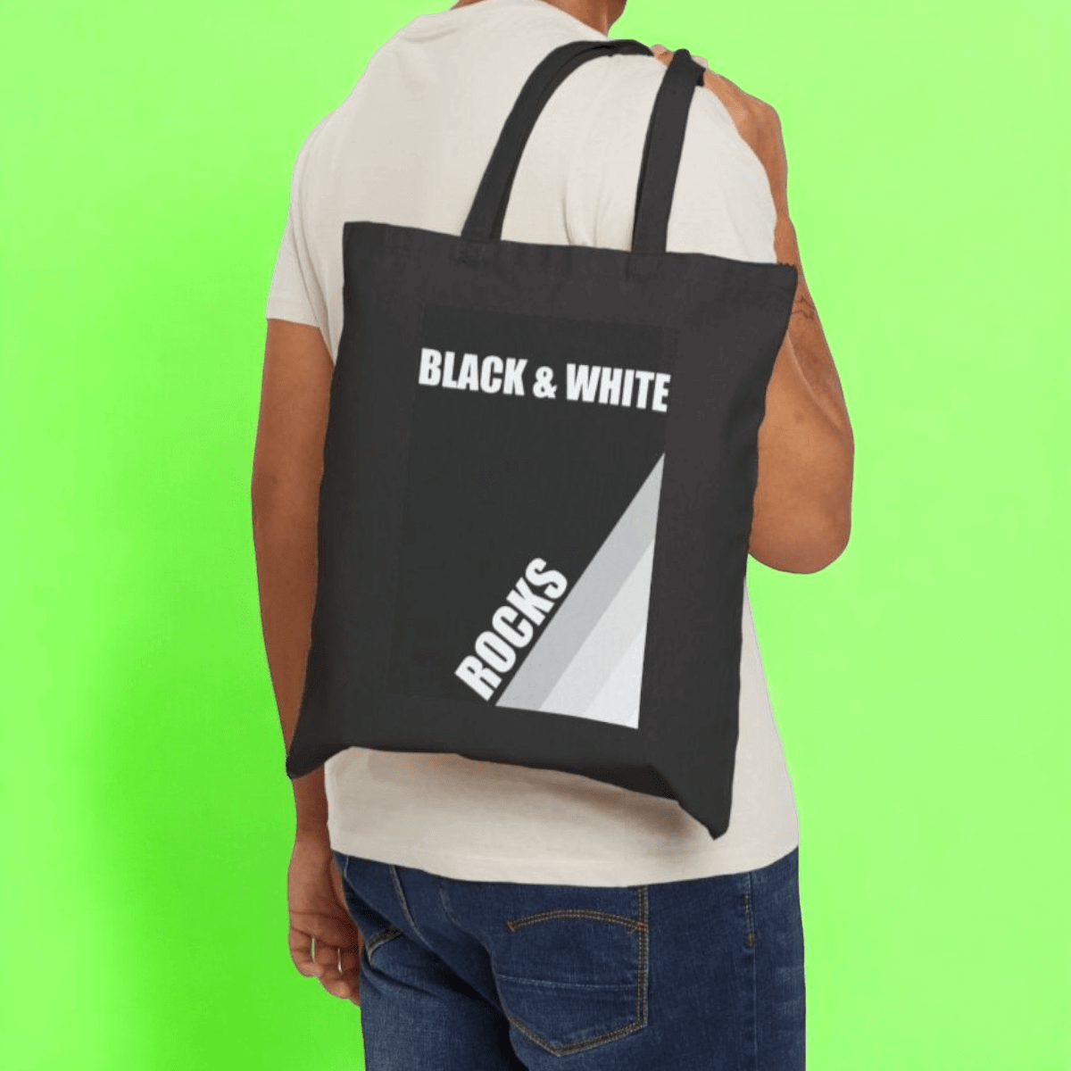 Black and white canvas tote bag with rock print and natural cotton handles in a casual style