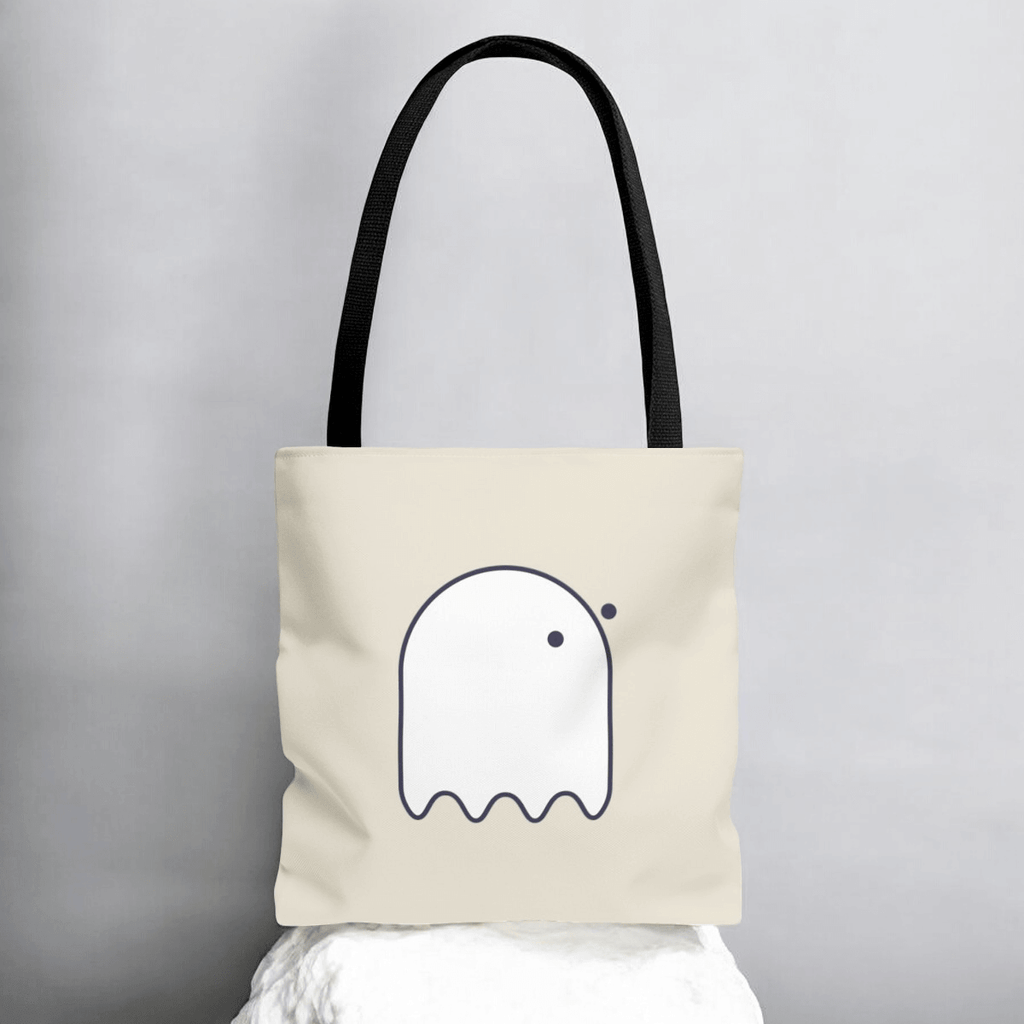 Beige tote bag with cartoon-like white ghost outline and black handles in minimalist style