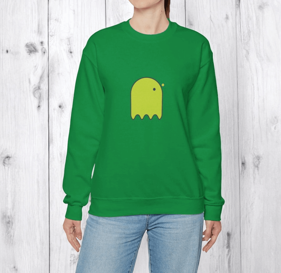 Green cotton sweatshirt featuring a bright yellow ghost graphic on the chest displayed against a wooden backdrop
