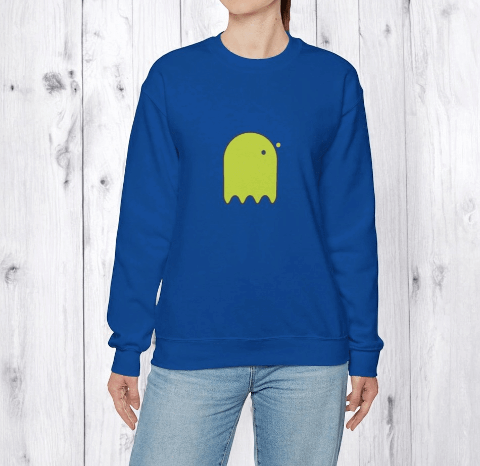Blue cotton sweatshirt with a green cartoon ghost print on the chest, styled casually with light wash jeans