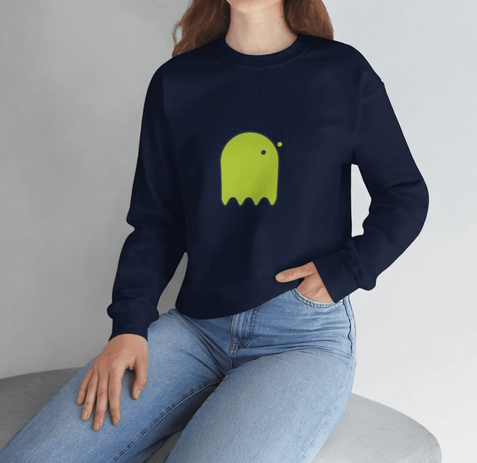 Navy cotton sweatshirt featuring a bright green ghost graphic, paired with light blue denim jeans in a relaxed fit
