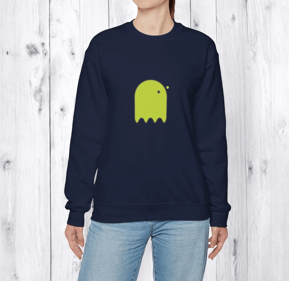 Navy blue cotton sweater with lime green ghost graphic on chest, paired with light blue denim jeans