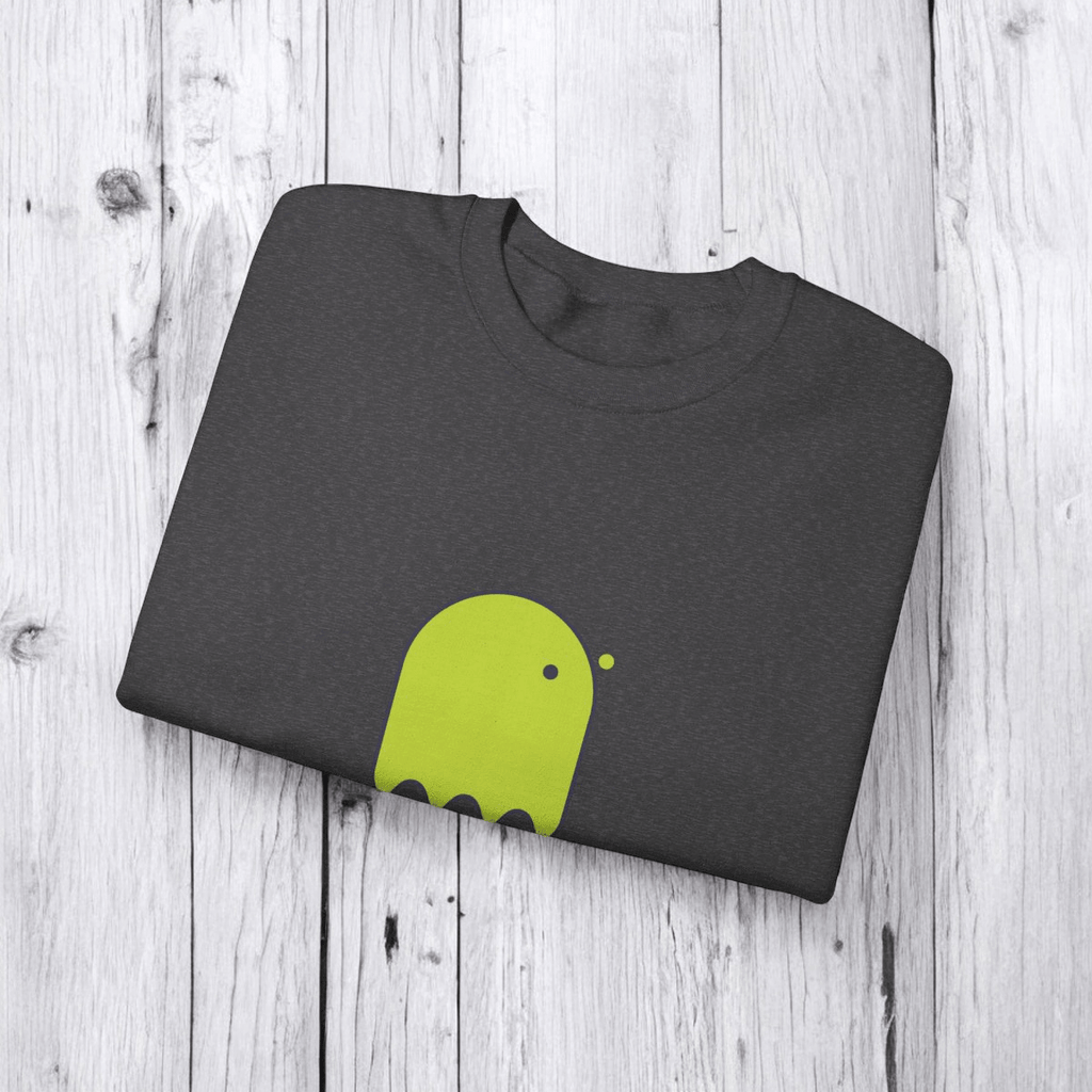 Folded gray cotton t-shirt with lime green abstract graphic, neatly folded on a light wooden surface