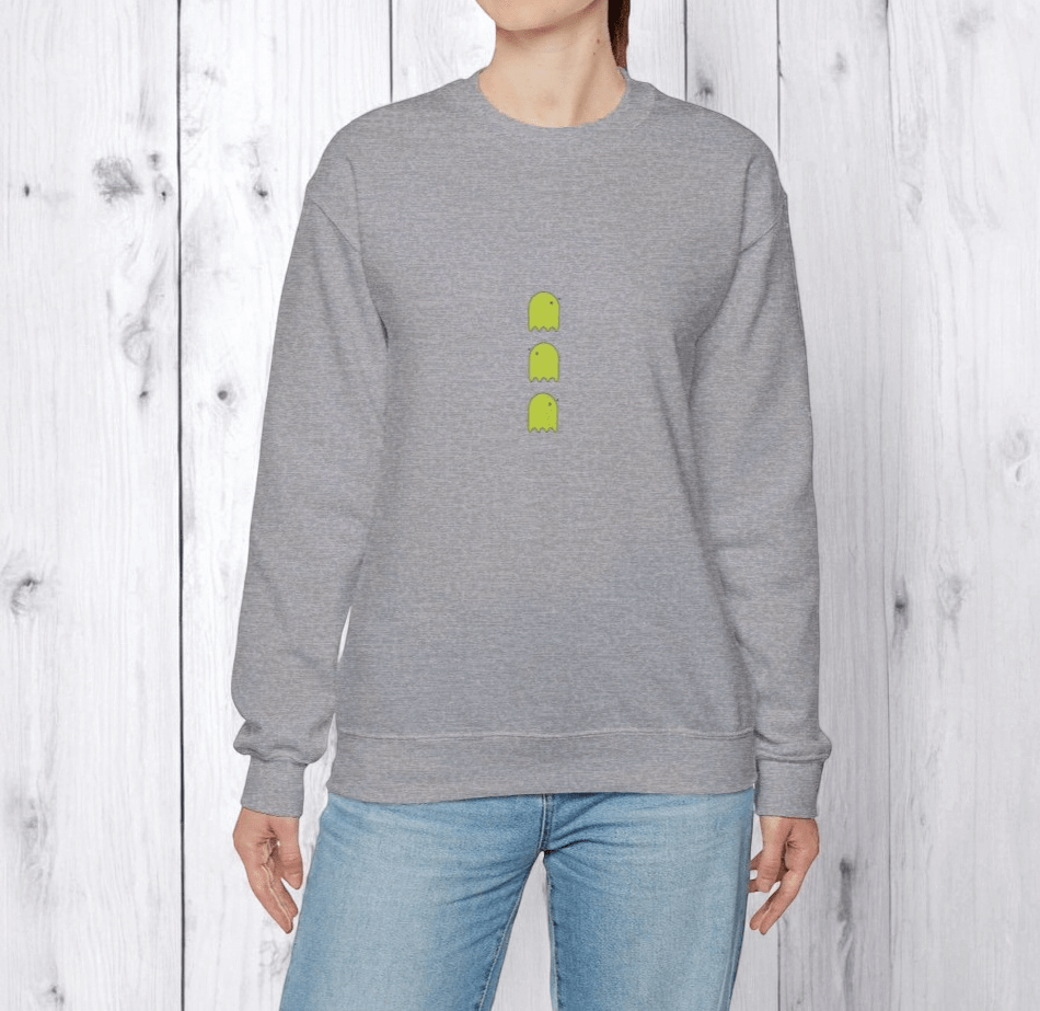 Gray cotton sweatshirt featuring green ghost icons on the chest, styled for casual wear on a wooden backdrop