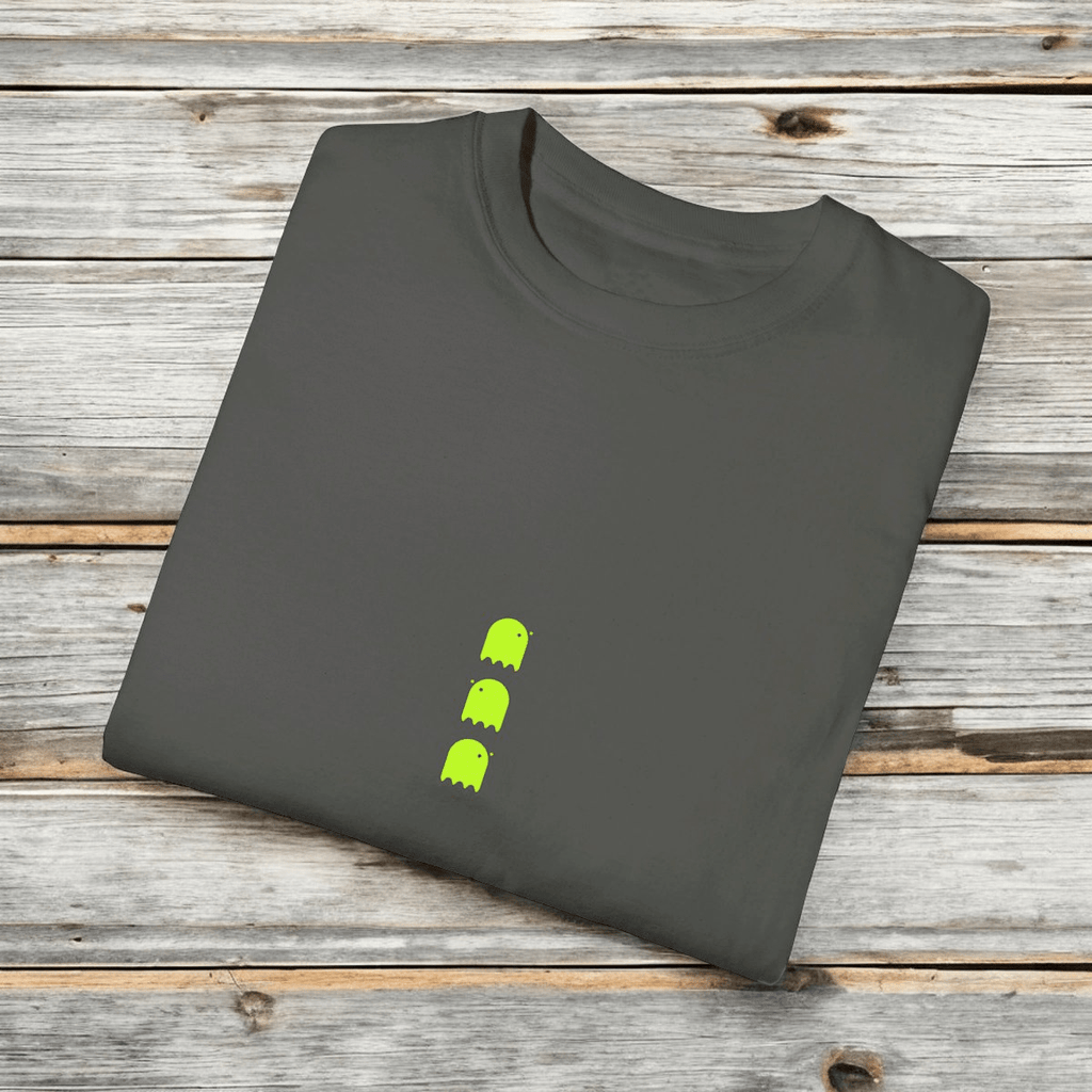 Gray cotton unisex T-shirt with crew neck and neon green ghost graphics folded neatly on a wooden surface