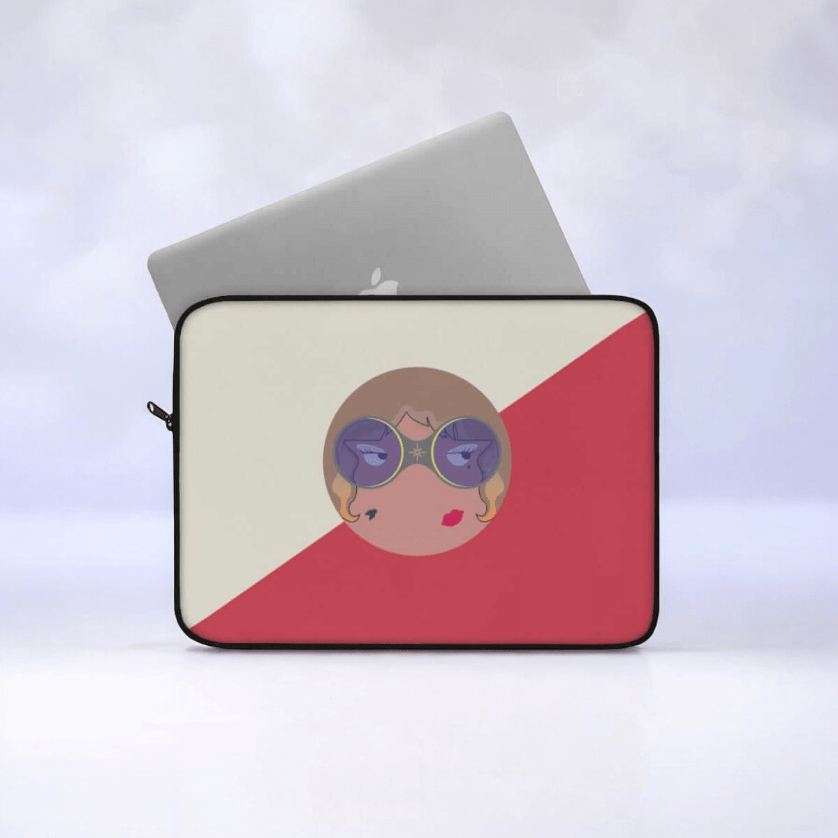 Laptop sleeve in red and cream canvas with stylized face illustration and zipper closure along the top edge
