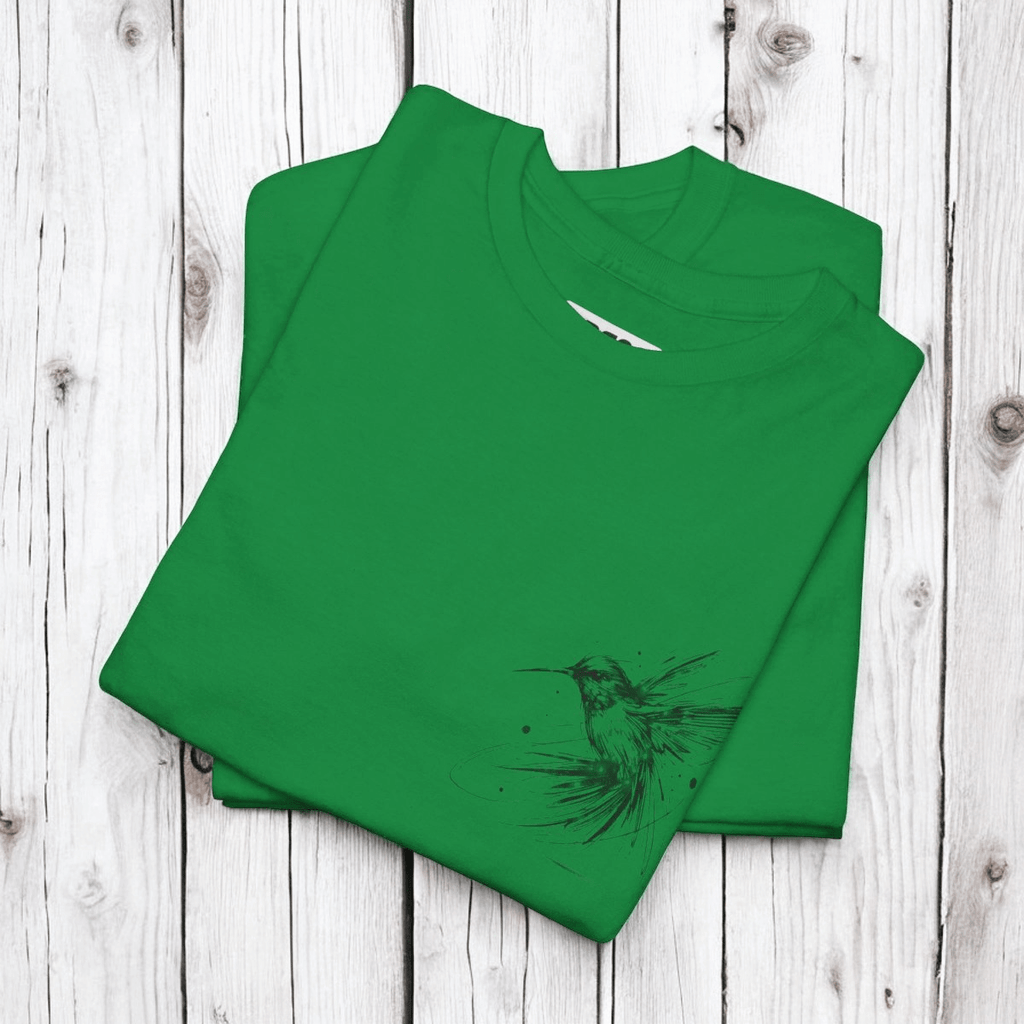 Green cotton T-shirt featuring a black hummingbird graphic on the front, displayed flat on a wooden surface