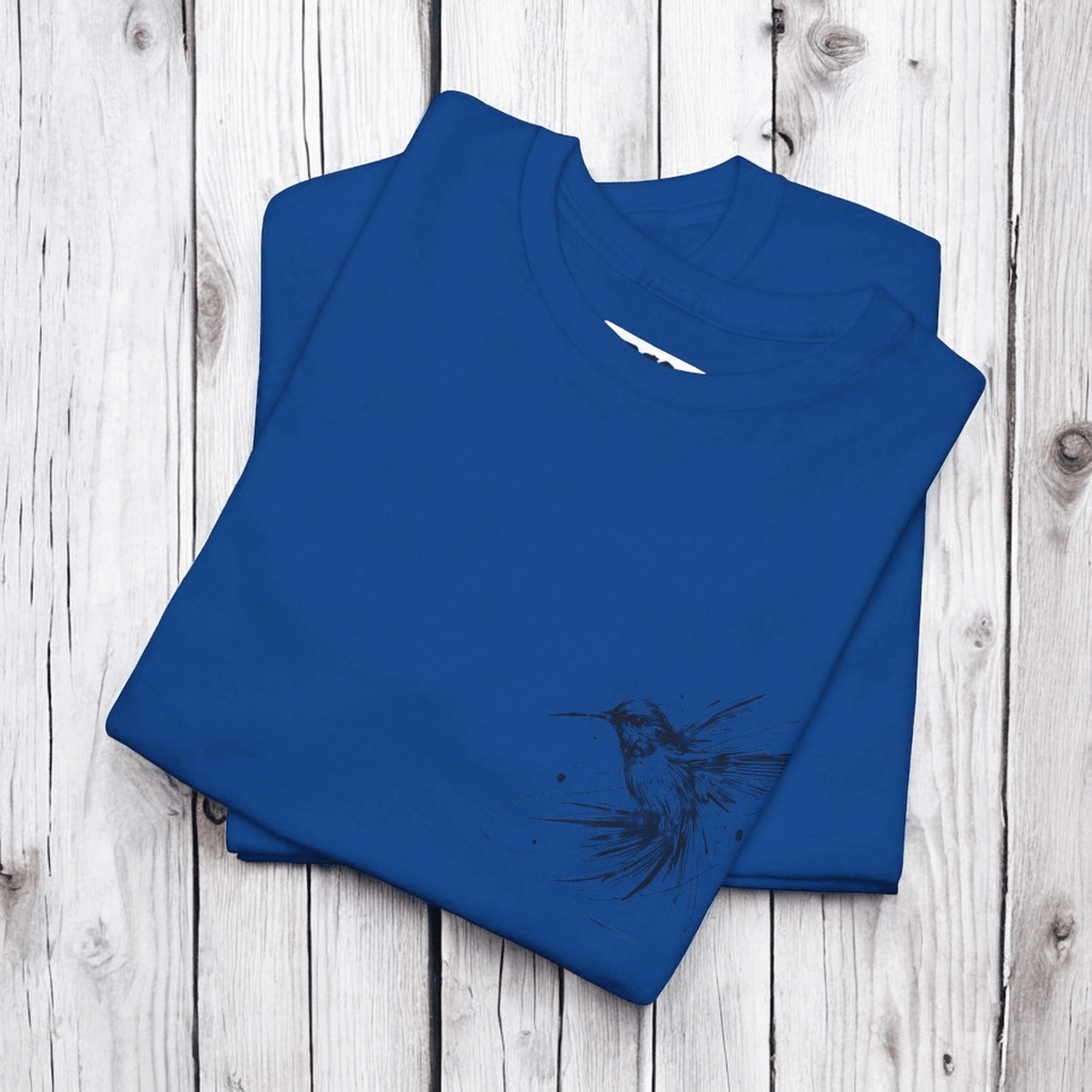 Blue cotton crew neck t-shirt with black hummingbird graphic printed on front, laid flat on wooden background