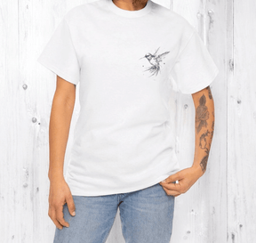 White cotton t-shirt with black bird graphic design worn with blue jeans, shown on tattooed person in casual setting
