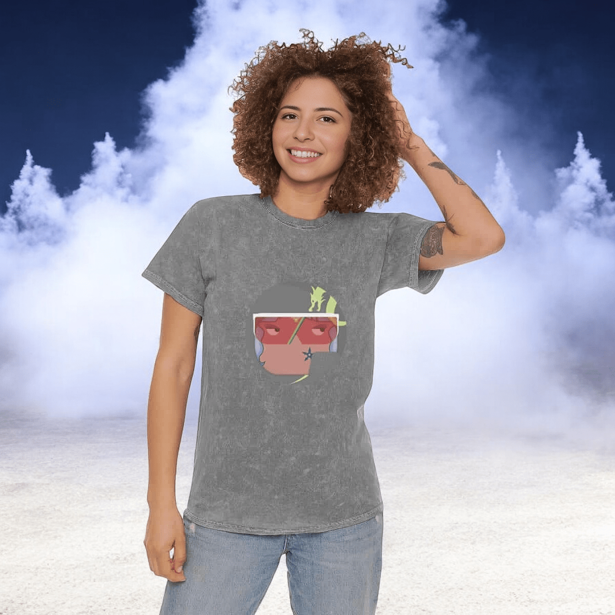 Gray cotton t-shirt featuring a colorful abstract front design worn by a person standing against a cloudy background