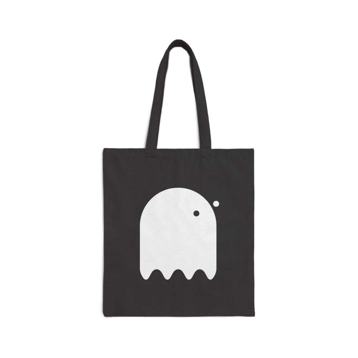 White canvas tote bag with black ghost graphic on front featuring black handles and simple open top design