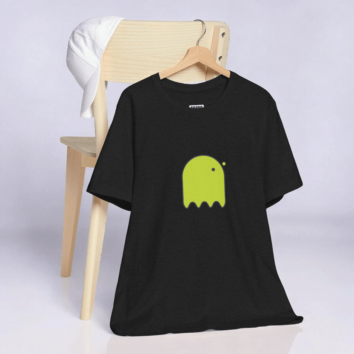 Black cotton blend t-shirt with yellow graphic of a button-eyed ghost printed on the front in a casual style